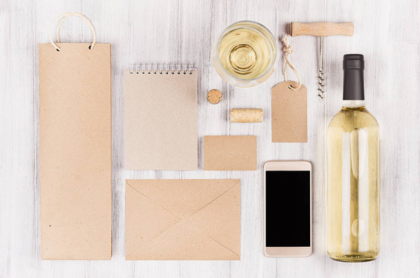 Corporate identity template for wine industry, packaging, stationery, phone, wineglass set with bottle white wine on soft white wood background.  - Zdjęcie, obraz