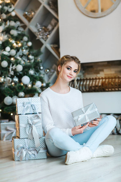 Beautiful young woman with Christmas gifts - Fotoğraf, Görsel