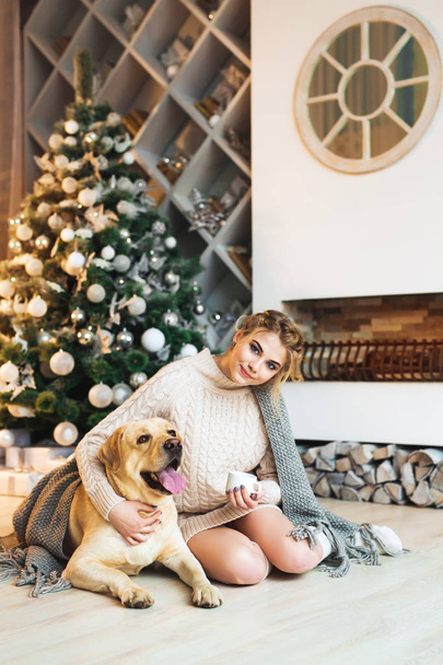 Gorgeous young woman with golden retriever dog - 写真・画像