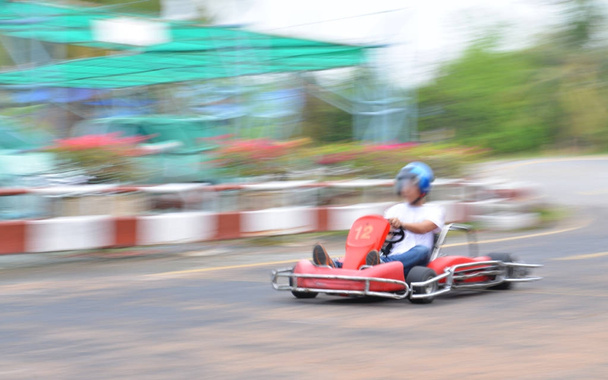 Young man driving to the kart with speed. - Photo, Image