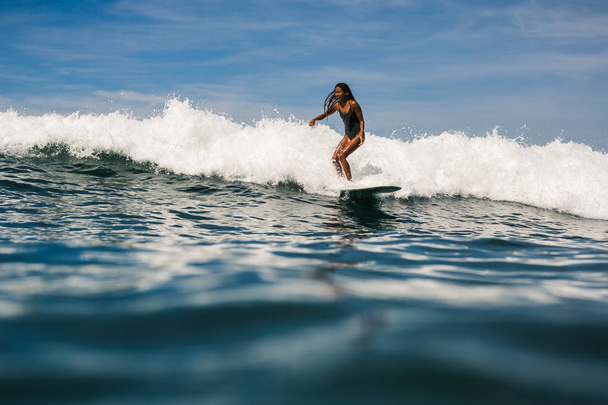 female surfer on surf board - Фото, изображение