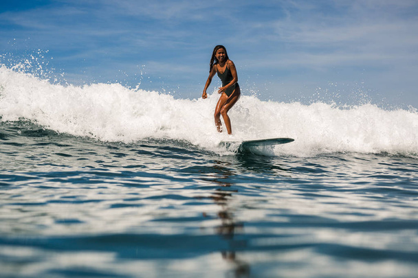 female surfer on surf board - Fotoğraf, Görsel