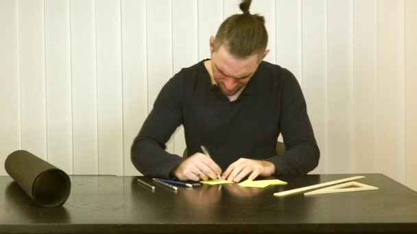 Man writing down and then strike through the text - Video