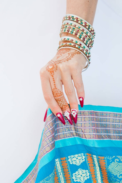 nails decorated with brilliant and hand with henna tattoos - Photo, Image