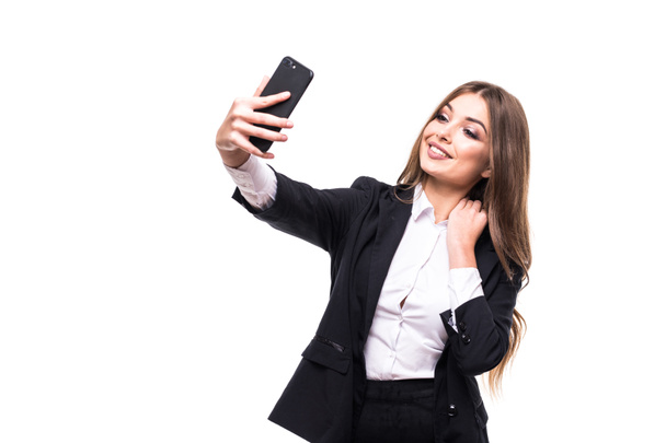 Closeup of beautiful playful business woman making selfie photo on white background and looking at camera - Foto, Imagem