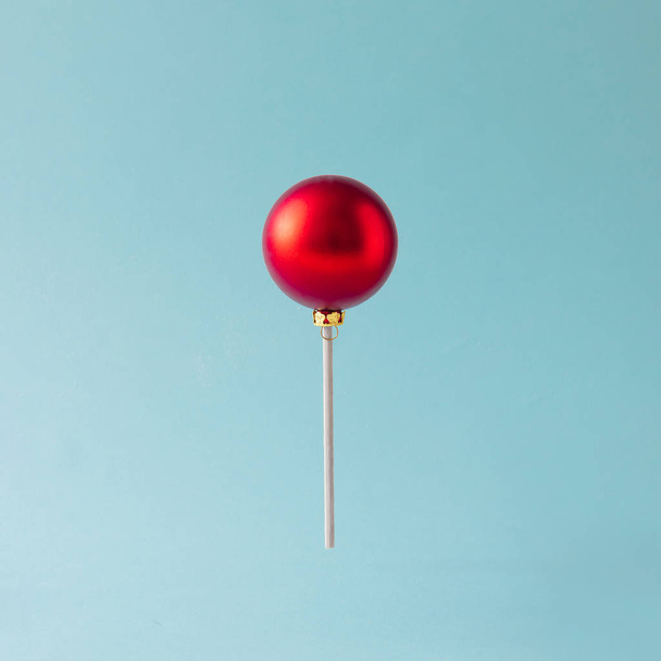 Lollipop made of red Christmas bauble - Fotoğraf, Görsel