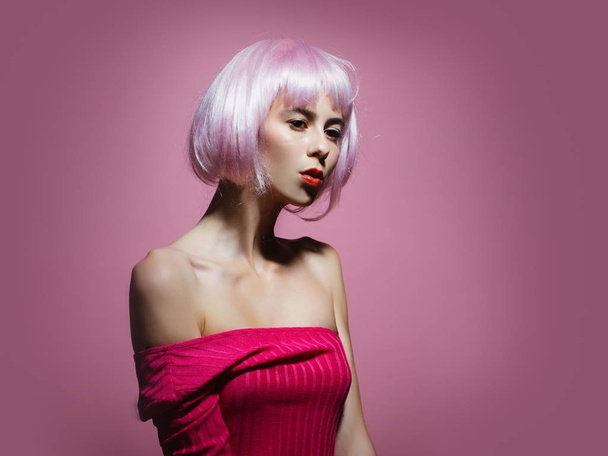 Woman in wig on pink background with fashionable make up - Foto, immagini