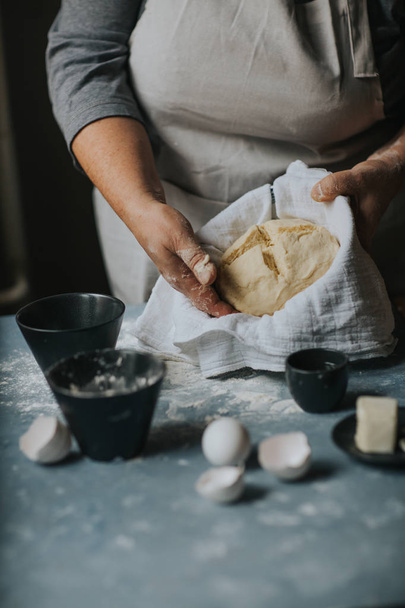 Woman working with dough. - Foto, imagen