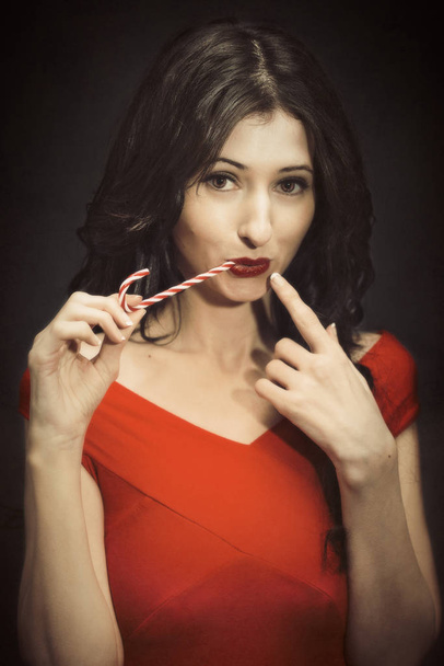 Young Woman At Christmas With Candy Cane - Fotografie, Obrázek