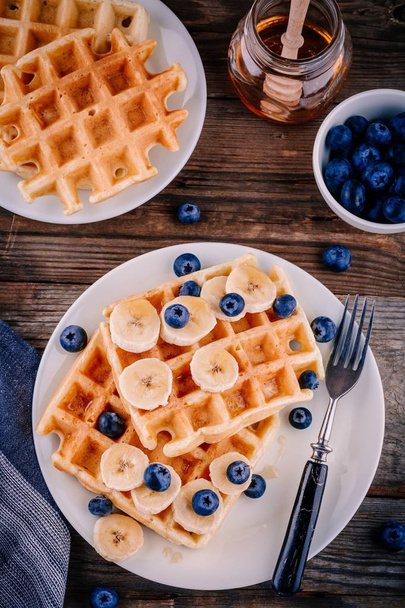 Fresh homemade belgian waffles with blueberries and banana for breakfast  - Photo, Image