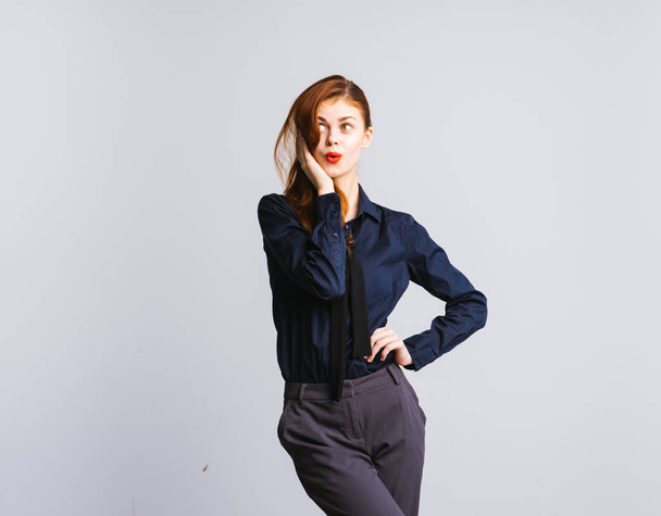 cute stylish redhead girl in blue shirt looking up thoughtfully - Valokuva, kuva