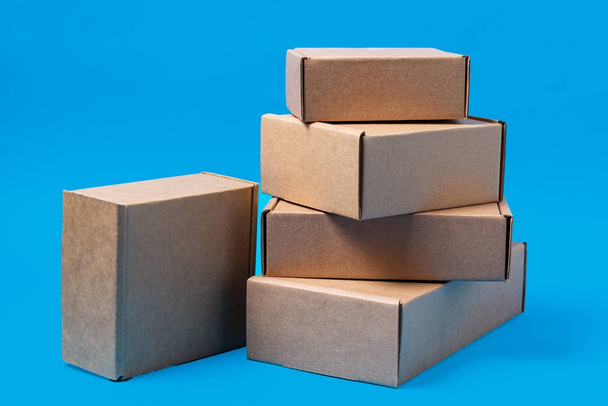 Lot of carton boxes on blue background - Foto, immagini