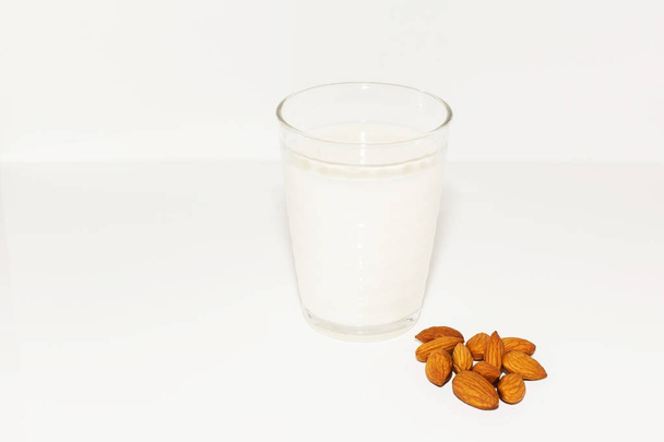 Glass of almond milk isolated on white - Foto, afbeelding