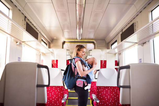 Young mother travelling with baby by train. - Photo, Image