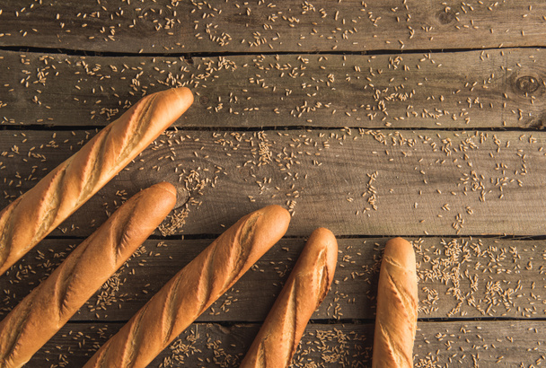 baguettes and grains on table - Foto, imagen