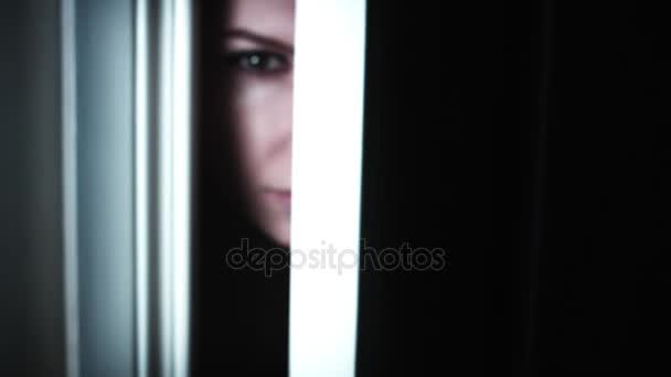 4k Thriller Kobieta Oko patrząc w szczeliny otworu drzwi, powiększyć - Materiał filmowy, wideo