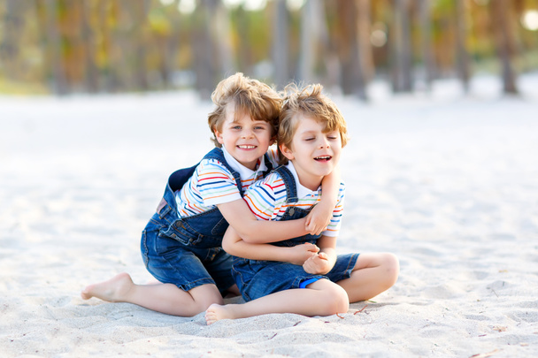 Two little kids boys having fun on tropical beach - Photo, Image
