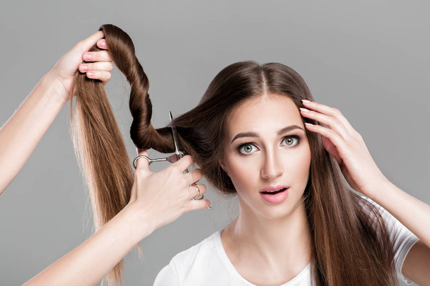 woman with  long hair holds scissors - Foto, Imagen