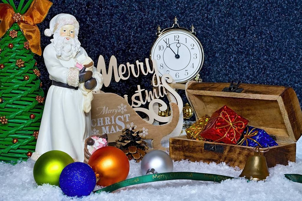 Vacances de Noël. Joyeux Noël. Thème de Noël. Carte de Noël avec Père Noël, boîte cadeau, boules de Noël avec horloge interne
. - Photo, image