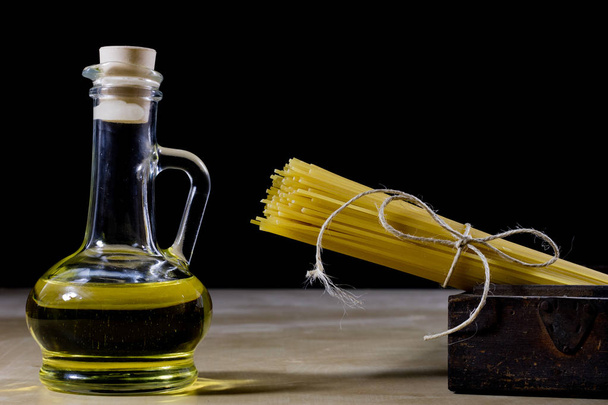 Pasta and olive oil on an old kitchen table. Recipes in old book - Foto, afbeelding