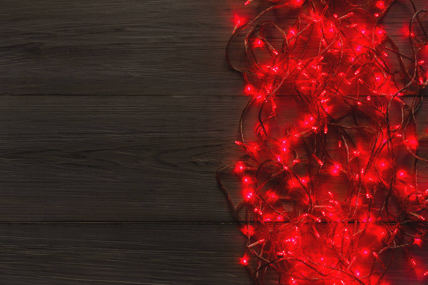 Christmas red lights border on grey wooden background - 写真・画像