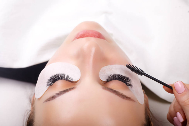 Eyelash Extension Procedure. Woman Eye with Long Eyelashes. Lashes, close up, macro, selective focus. - Фото, изображение