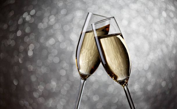 Photo of two glasses with champagne on gray background, - Фото, изображение