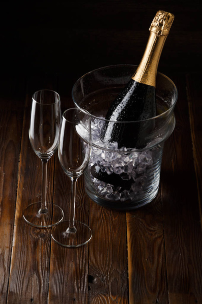 Picture of two glasses, bucket of ice and bottle of wine - Photo, Image
