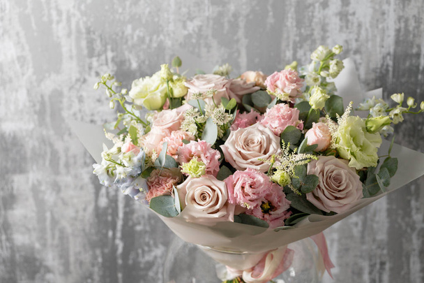 beautiful bouquet of mixed flowers into a vase on wooden table. copy space - Фото, зображення