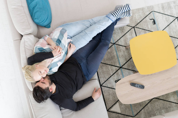 Young couple on the sofa watching television top view - Foto, Bild