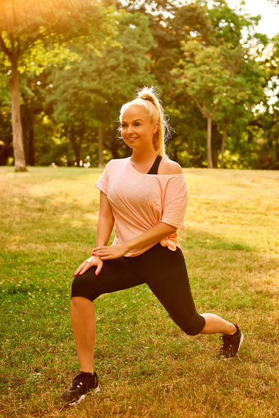 Young woman stretching on the field - Photo, Image