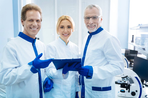 Smiling biologists standing together in the lab - Фото, изображение
