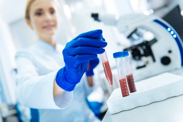Female research holding blood test tubes - Φωτογραφία, εικόνα