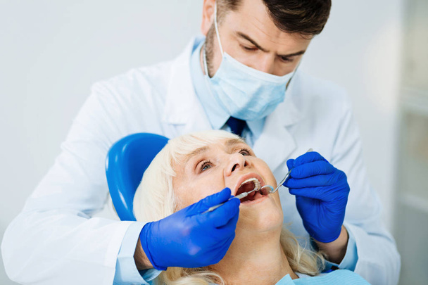 Close up of diligent dental surgeon - Foto, immagini