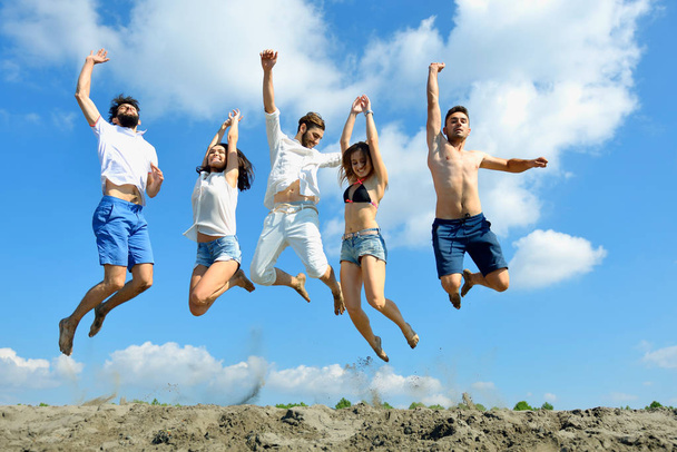 Image of young people jumping together outdoor. - Fotografie, Obrázek