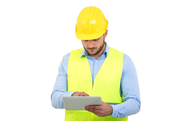Handsome engineer working with a tablet pc, isolated on white - Foto, Imagem
