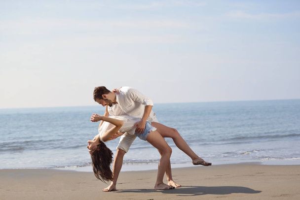 happy young romantic couple in love have fun on beautiful beach at beautiful summer day. - Foto, Bild