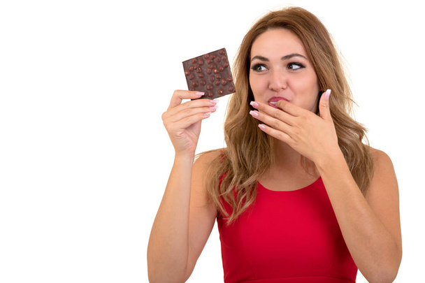 health, people, food and beauty concept - Lovely smiling teenage girl eating chocolate - Фото, изображение
