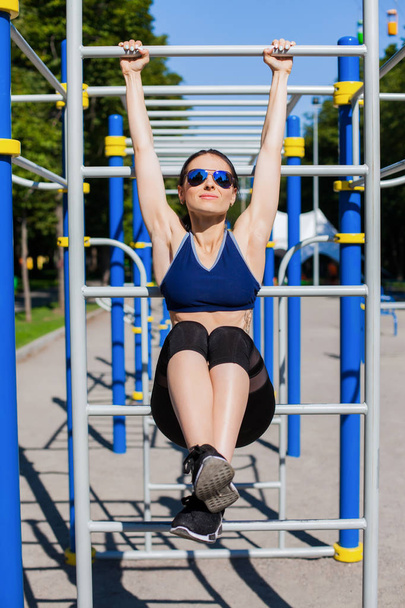 athletic woman trainer on sport playground - Fotó, kép