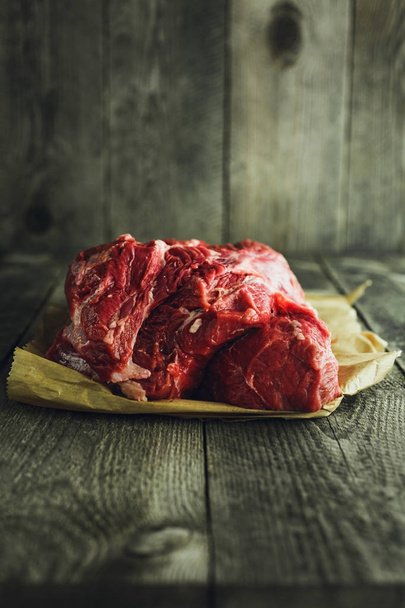 Raw meat on a wooden background - Photo, Image