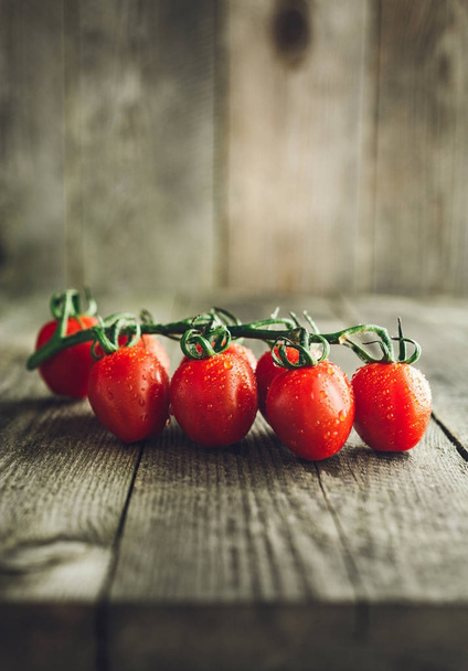 Cherry tomatoes on wooden background - Фото, изображение