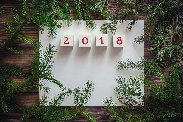 Christmas background with paper fir branches and a happy new year 2018 - Photo, image