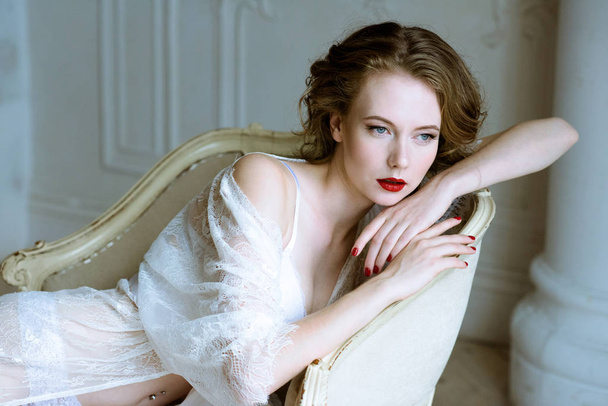 Fashionable female portrait of cute lady in white robe indoors - Fotografie, Obrázek
