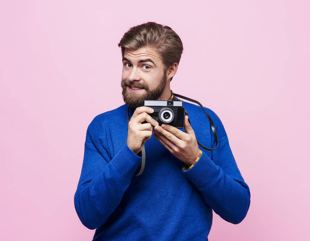 Portrait of man holding camera - Photo, Image