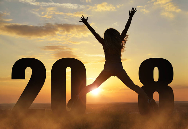 Girl jumps up while celebrating New Year 2018. - Foto, Bild