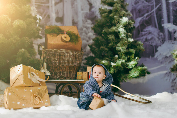 Playful happy cute little baby boy in a decorated forest with fi - Фото, зображення