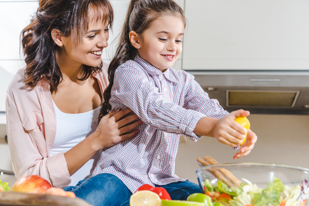 mother with daughter making salad - Photo, Image