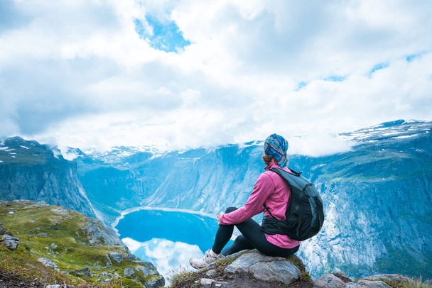 Young woman with backpack on top of fjord Norway - Valokuva, kuva