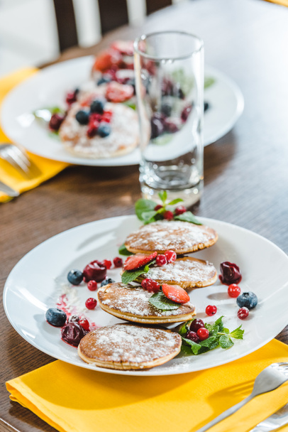 pancakes with berries on plates - Фото, зображення