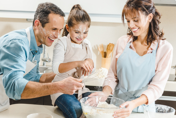 happy caucasian family in flour making dough at kitchen - Photo, Image